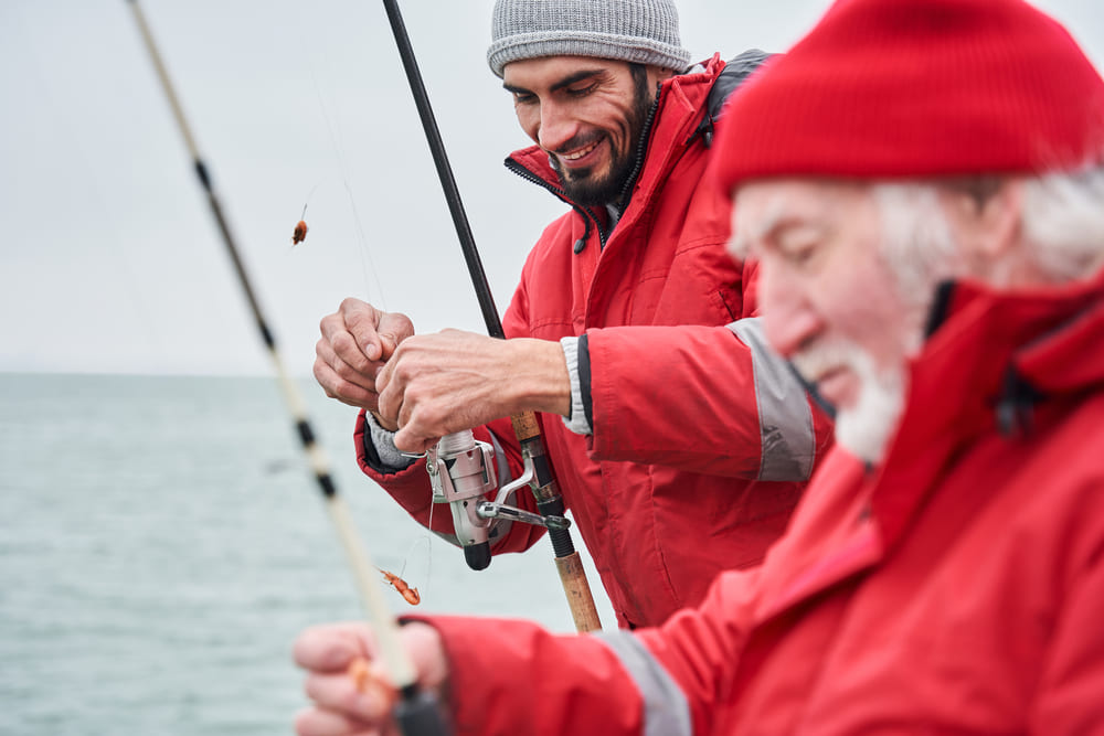 A fisherman guiding a man on a fishing trip