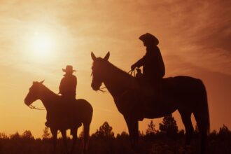 Cowboys riding horses during a guided adventure in Ruby Valley, Montana